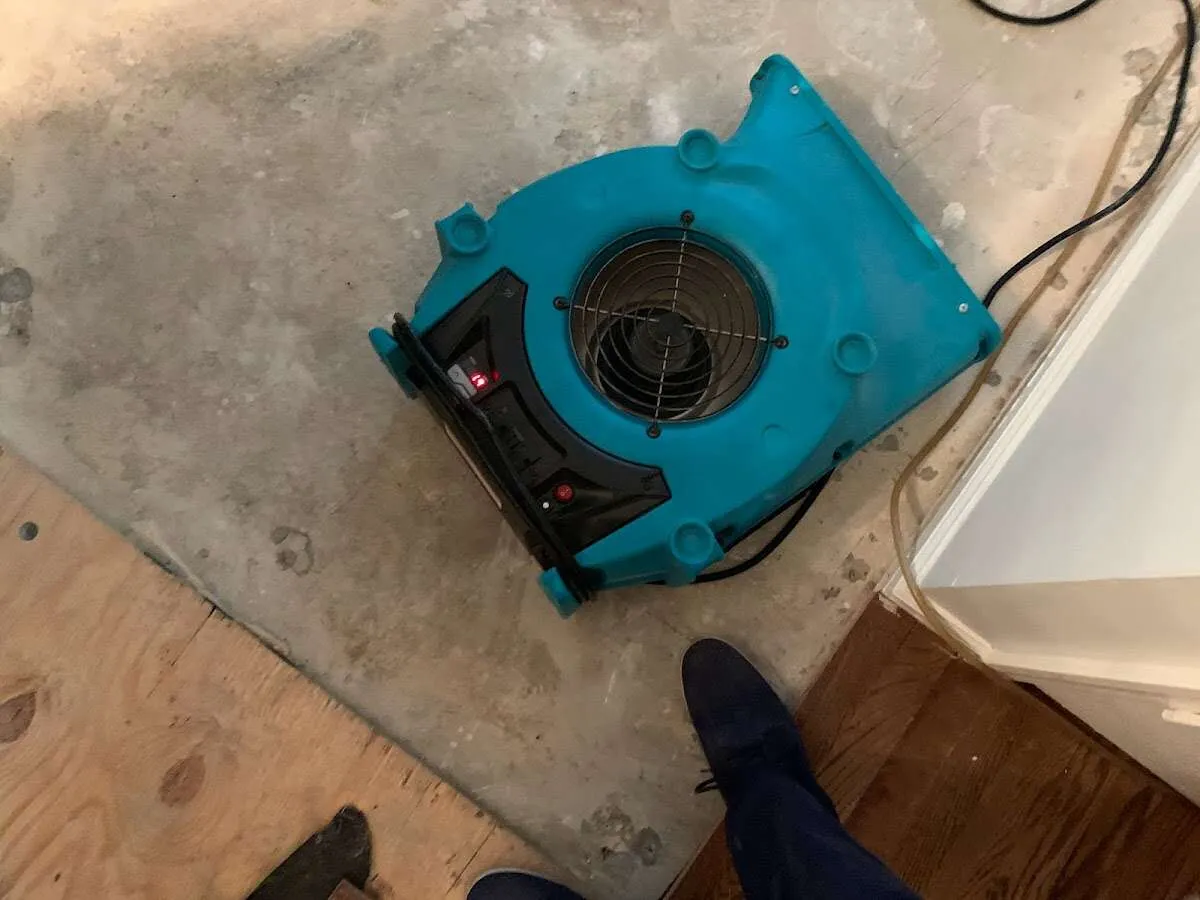 Air mover drying subfloor during Commercial Water Damage Restoration in Fort Leonard Wood